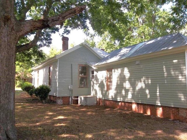 view of side of property with central AC