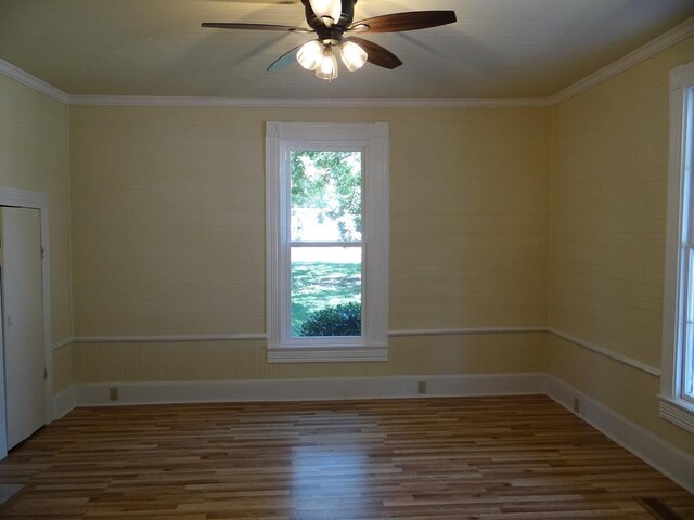 unfurnished room with ceiling fan, crown molding, and wood-type flooring