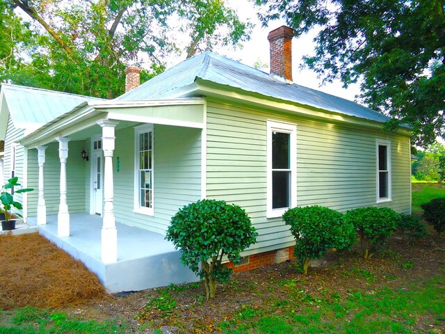 view of side of property with covered porch