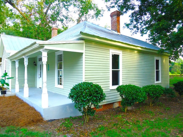 view of side of property with a porch