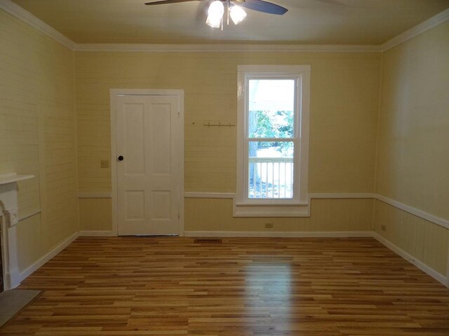 spare room with crown molding, ceiling fan, and wood-type flooring