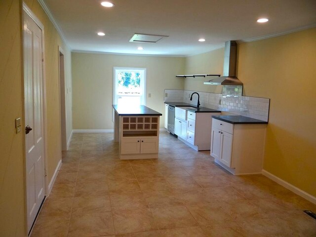 kitchen with decorative backsplash, extractor fan, crown molding, a center island, and white cabinetry