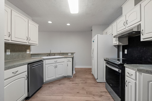 180 Plum Ct, Columbus, GA 31909 - kitchen with appliances with stainless steel finishes, under cabinet range hood, a peninsula, recessed lighting, and white cabinets