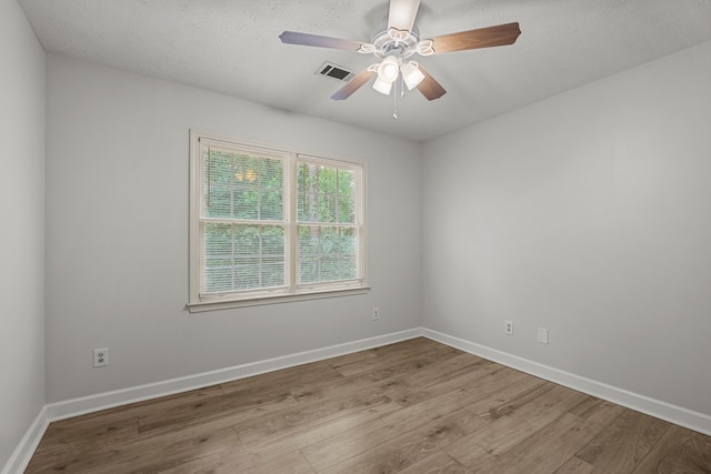 180 Plum Ct, Columbus, GA 31909 - empty room with wood finished floors, ceiling fan, and a textured ceiling