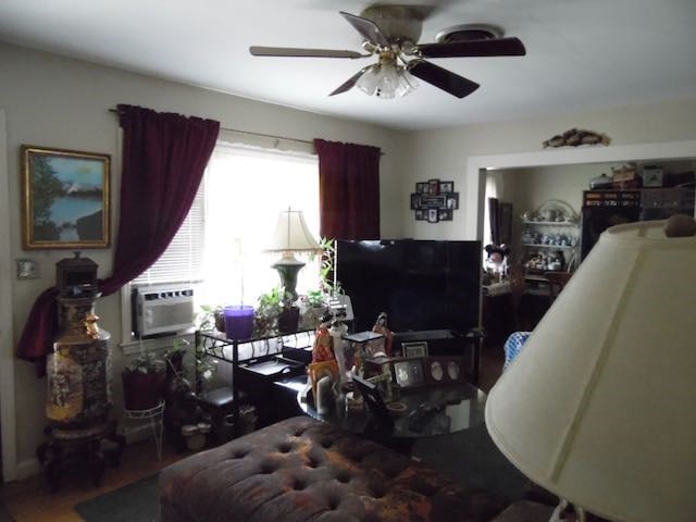 interior space with ceiling fan and an AC wall unit