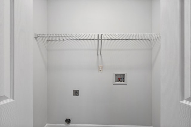 clothes washing area with laundry area, hookup for a washing machine, and electric dryer hookup