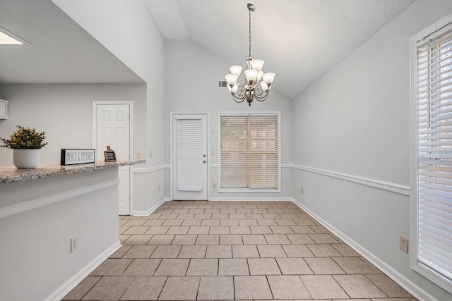 foyer featuring a notable chandelier, lofted ceiling, visible vents, light tile patterned flooring, and baseboards