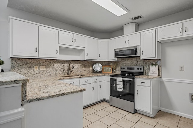 kitchen featuring white cabinetry, appliances with stainless steel finishes, tasteful backsplash, and a sink