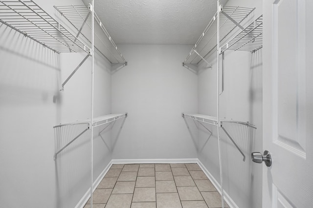 walk in closet featuring light tile patterned flooring