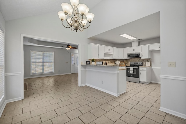 kitchen with tasteful backsplash, appliances with stainless steel finishes, light tile patterned flooring, white cabinetry, and a peninsula