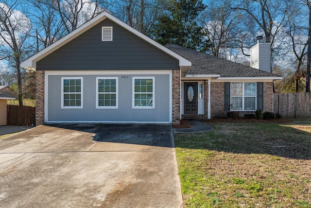 ranch-style home featuring brick siding, a chimney, a front lawn, and fence