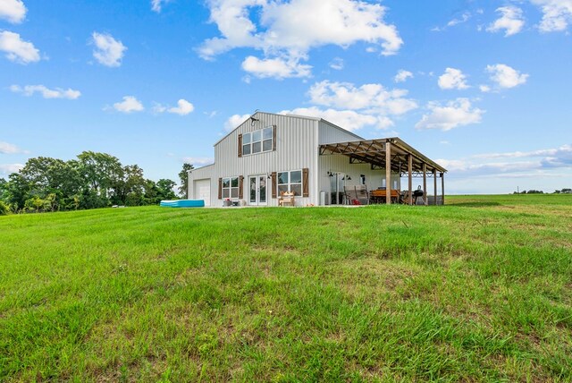 129 Hayes Rd, Mauk, GA 31058 - rear view of property featuring a lawn and a garage