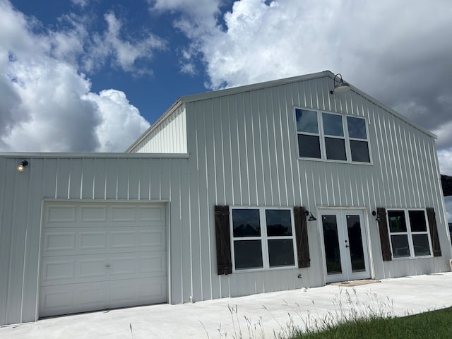 129 Hayes Rd, Mauk, GA 31058 - view of home's exterior with french doors, an attached garage, and board and batten siding