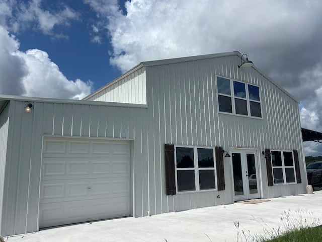 129 Hayes Rd, Mauk, GA 31058 - view of home's exterior featuring french doors, an attached garage, and board and batten siding