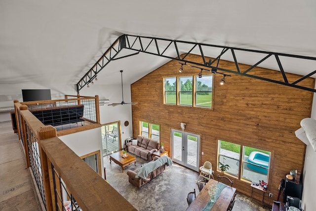 129 Hayes Rd, Mauk, GA 31058 - living room featuring high vaulted ceiling, plenty of natural light, wood walls, french doors, and ceiling fan