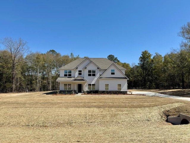 view of front of home featuring roof with shingles