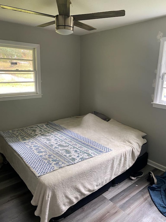 bedroom with ceiling fan and wood-type flooring