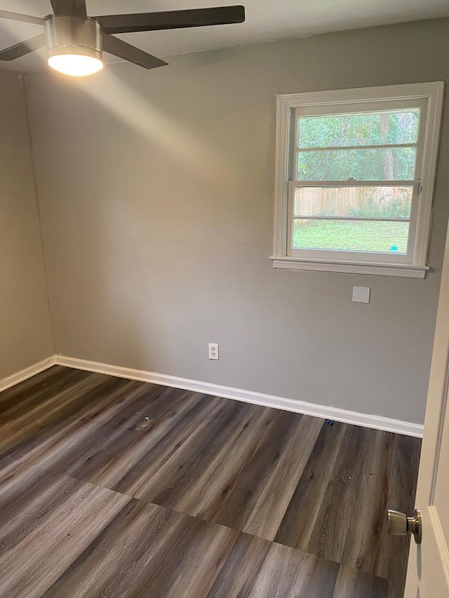 empty room featuring ceiling fan and dark hardwood / wood-style flooring