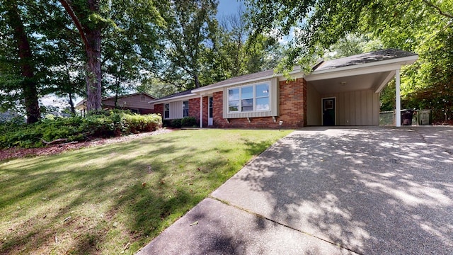 ranch-style house with driveway, brick siding, a front yard, and an attached carport
