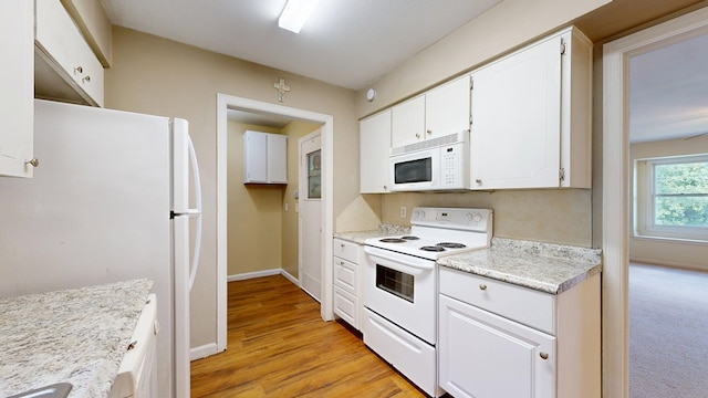 kitchen featuring white appliances, light countertops, white cabinetry, and baseboards