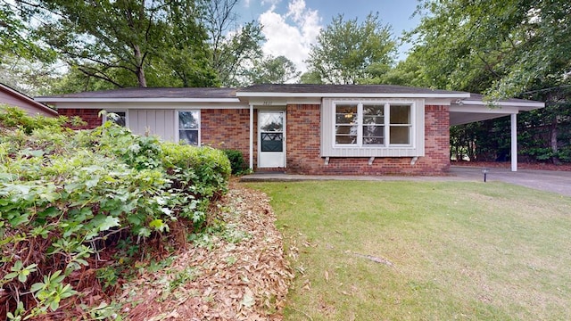 ranch-style home with a front lawn, brick siding, a carport, and asphalt driveway