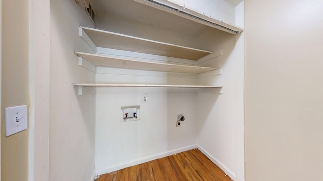 laundry area featuring wood finished floors, washer hookup, baseboards, and electric dryer hookup