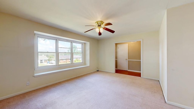 unfurnished room featuring carpet flooring, ceiling fan, and baseboards