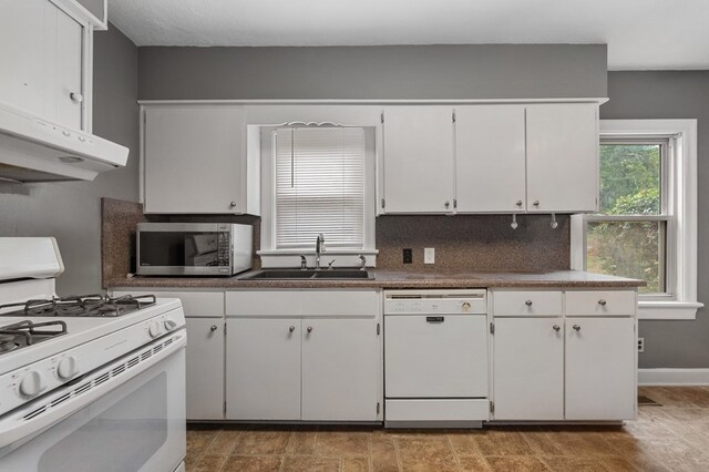 kitchen featuring white cabinetry, white appliances, and sink