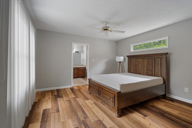 bedroom featuring ensuite bath, ceiling fan, and light hardwood / wood-style floors