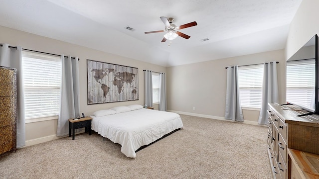 bedroom with light colored carpet, multiple windows, visible vents, and baseboards