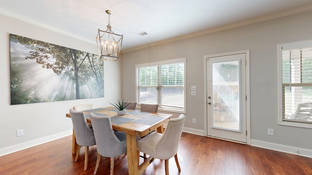 dining space with a notable chandelier, a healthy amount of sunlight, visible vents, and wood finished floors