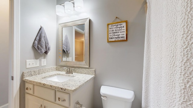 bathroom with toilet and vanity