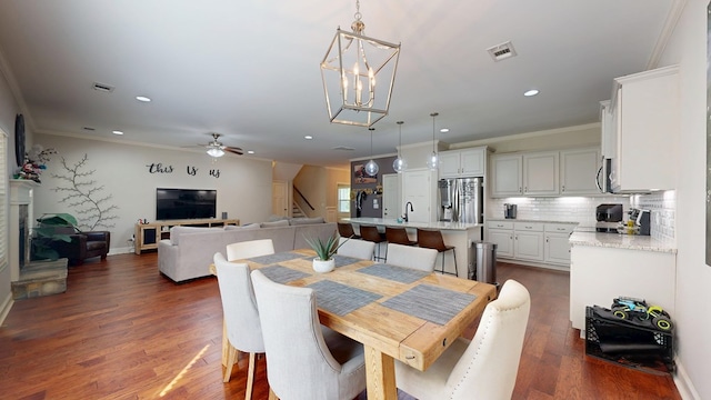 dining space with a ceiling fan, recessed lighting, ornamental molding, and visible vents