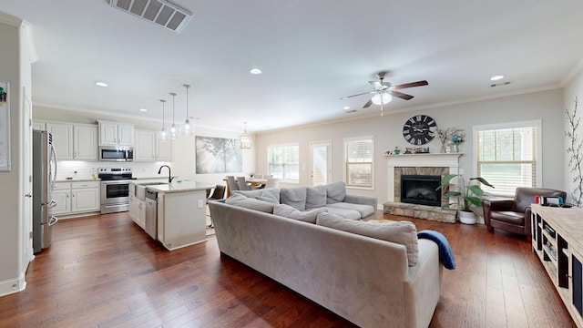 living room with ceiling fan, a wealth of natural light, visible vents, and recessed lighting
