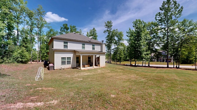 rear view of property with a patio area and a lawn
