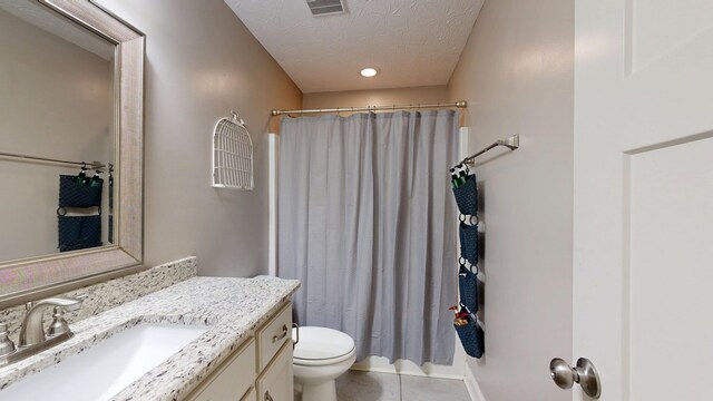 bathroom with toilet, a shower with shower curtain, visible vents, tile patterned flooring, and vanity