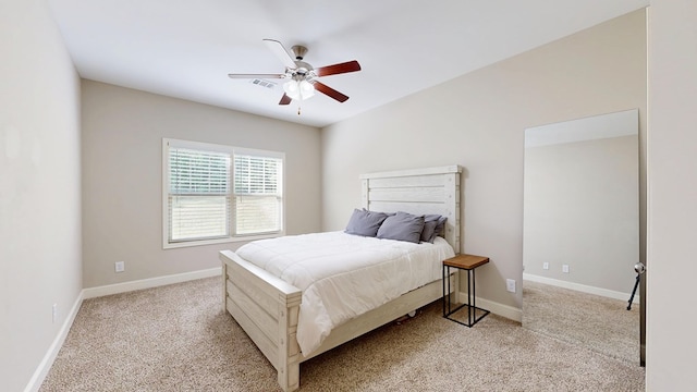 carpeted bedroom featuring baseboards, visible vents, and ceiling fan