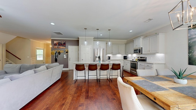 dining room featuring recessed lighting, dark wood-style flooring, visible vents, crown molding, and stairway