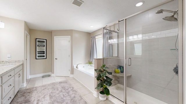 bathroom with vanity, visible vents, tile patterned flooring, a shower stall, and a garden tub
