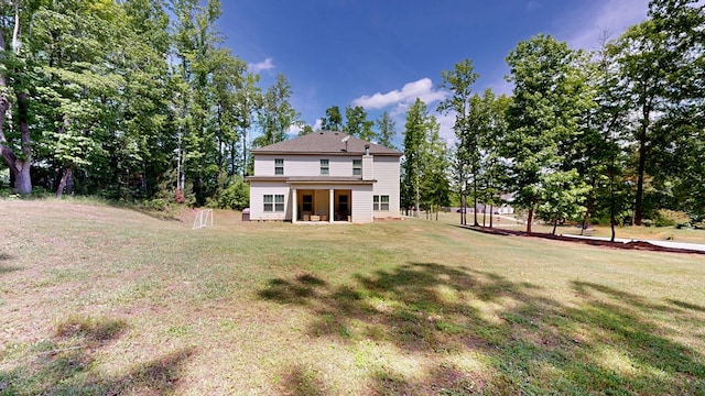 rear view of property featuring a yard