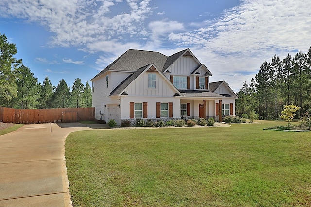 craftsman house featuring a front lawn and a garage