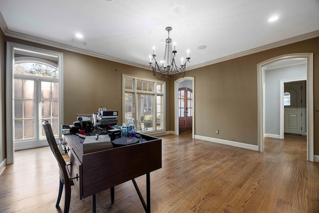 office space featuring ornamental molding, a chandelier, and light hardwood / wood-style floors