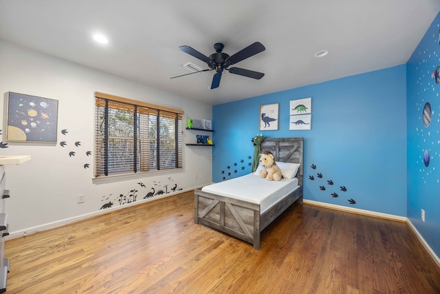 bedroom featuring hardwood / wood-style flooring and ceiling fan