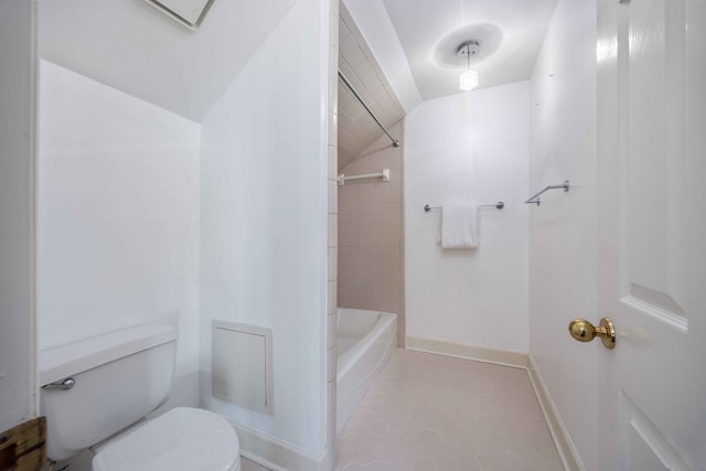 bathroom with lofted ceiling, toilet, and tile patterned flooring