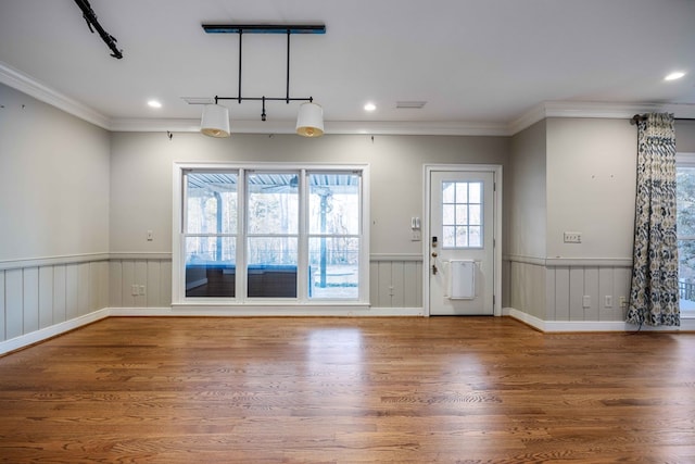 interior space featuring hardwood / wood-style flooring and crown molding