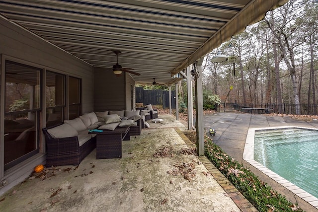 view of patio with a fenced in pool, outdoor lounge area, and ceiling fan