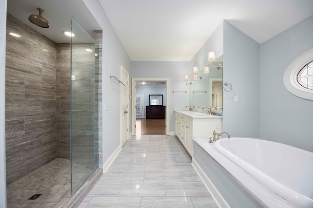 bathroom featuring shower with separate bathtub and vanity