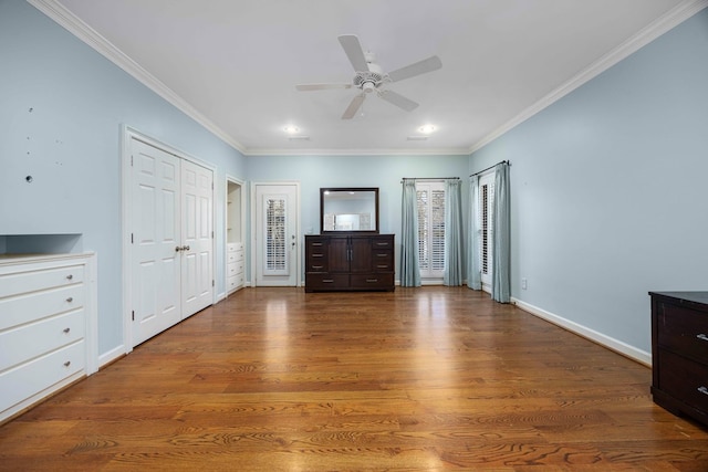 unfurnished bedroom featuring crown molding, ceiling fan, and wood-type flooring