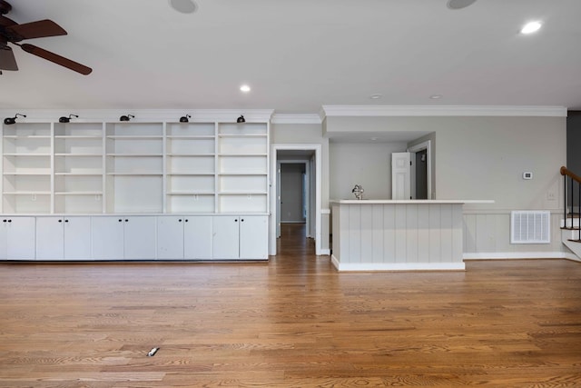 unfurnished living room featuring ornamental molding, ceiling fan, and light hardwood / wood-style flooring