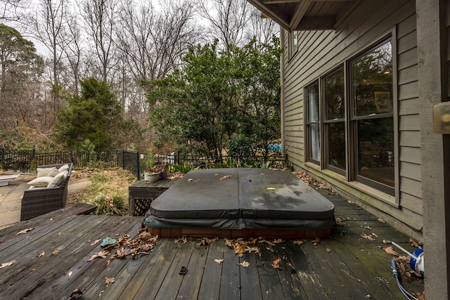 deck with a covered hot tub and an outdoor living space